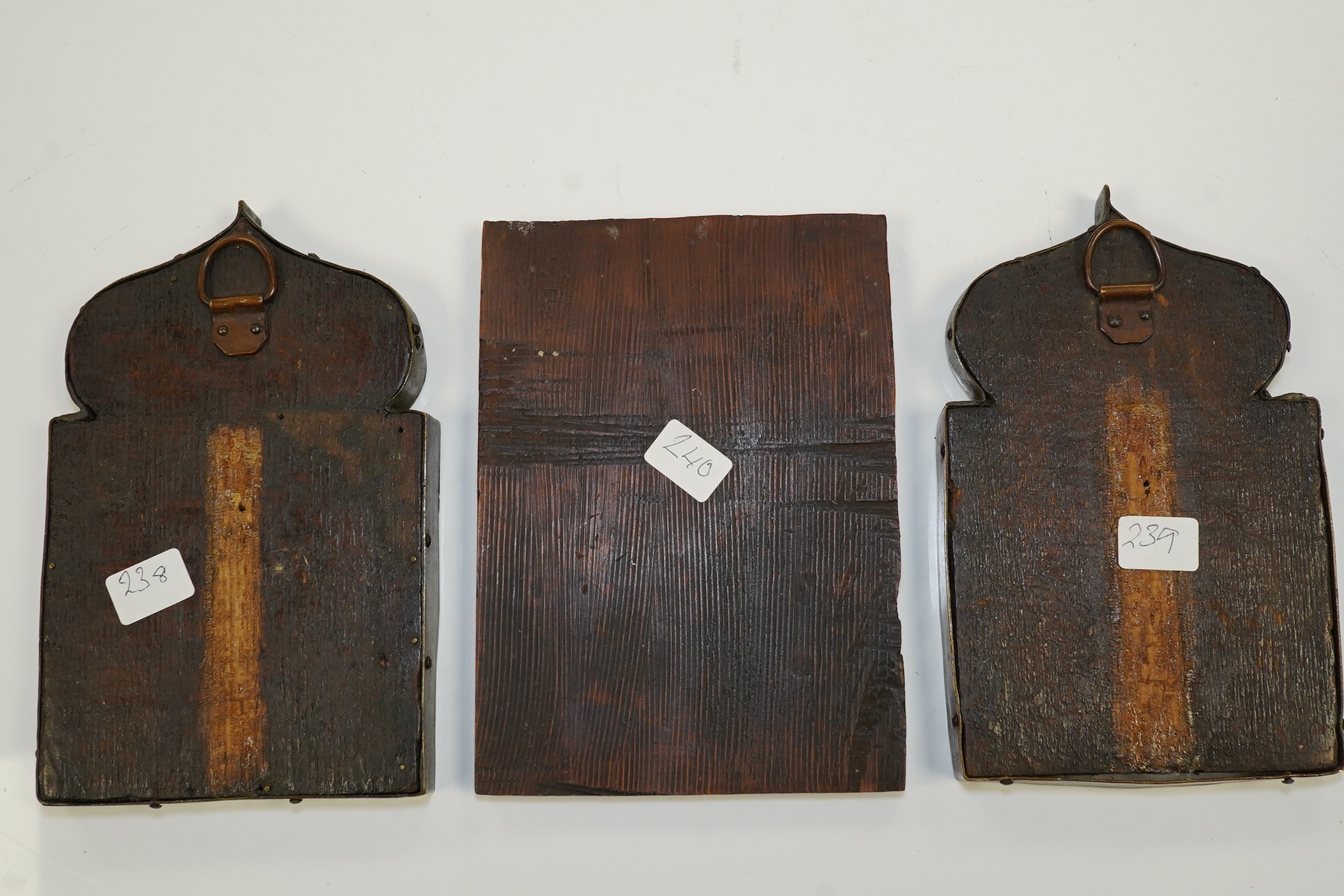 A pair of 17th century or later Russian painted wood icons, and another similar, 13.5 x 10cm. Condition - poor to fair